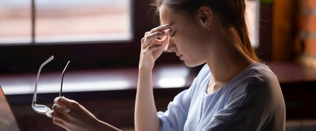 A lady rubbing her after after looking at a computer screen for to long